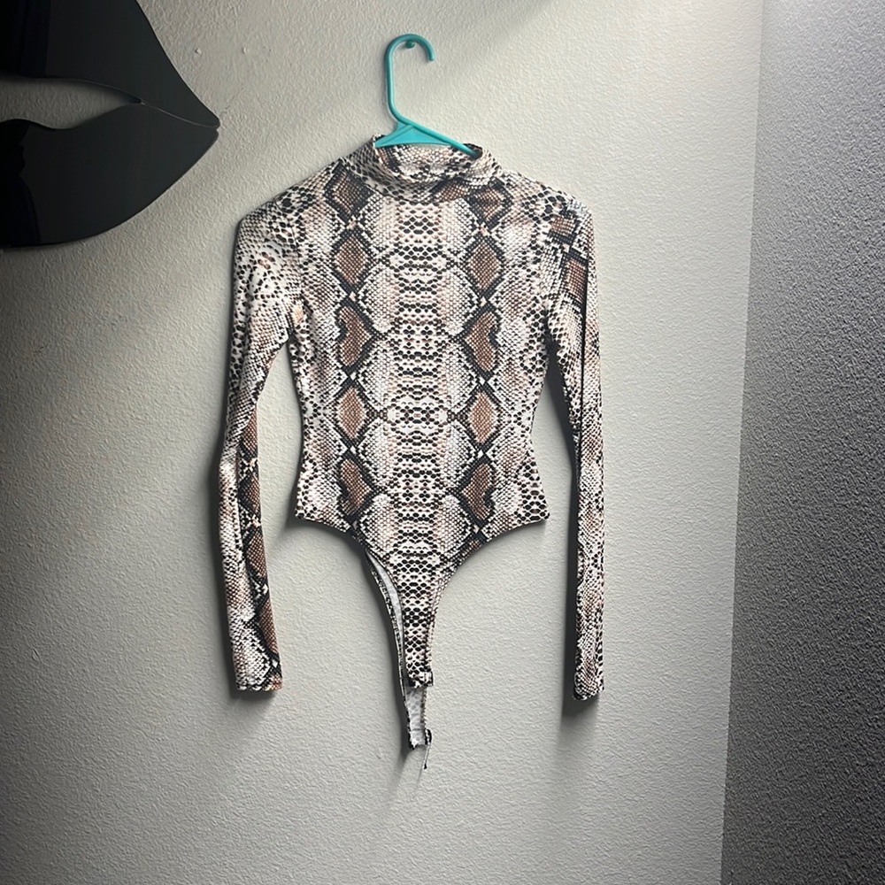 This is a small snake print shirt it’s still in really good condition.